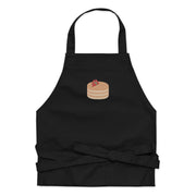 Kitchen apron embroidered on the front. The design is of pancakes with 3 strawberries on top, in a graphic are / vector art style. Apron features 2 front pockets and long straps to be tied behind the wearer in the usual manner. Unisex. One Size. Color: Black. Designed by Brekky Threads.