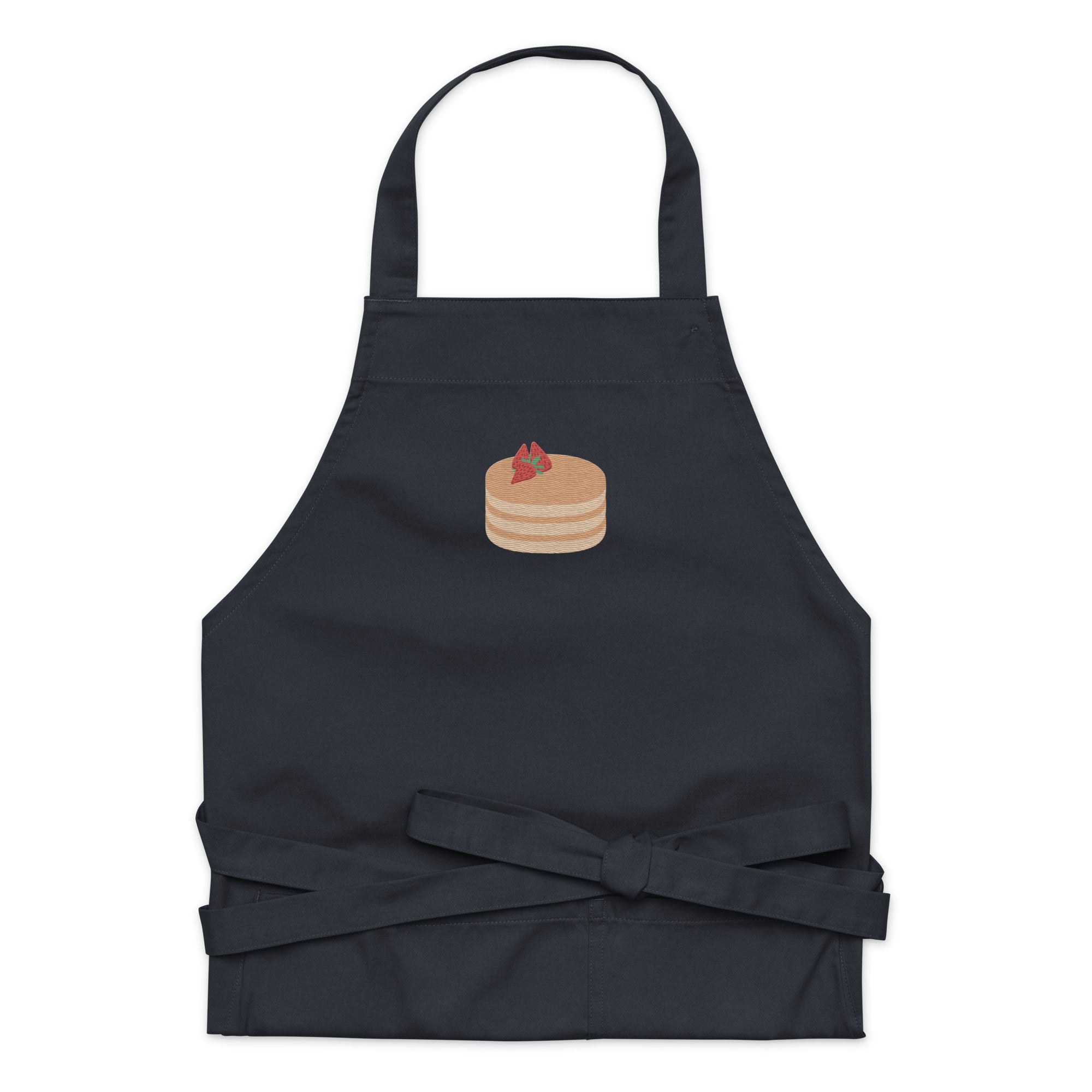 Kitchen apron embroidered on the front. The design is of pancakes with 3 strawberries on top, in a graphic are / vector art style. Apron features 2 front pockets and long straps to be tied behind the wearer in the usual manner. Unisex. One Size. Color: Navy. Designed by Brekky Threads.