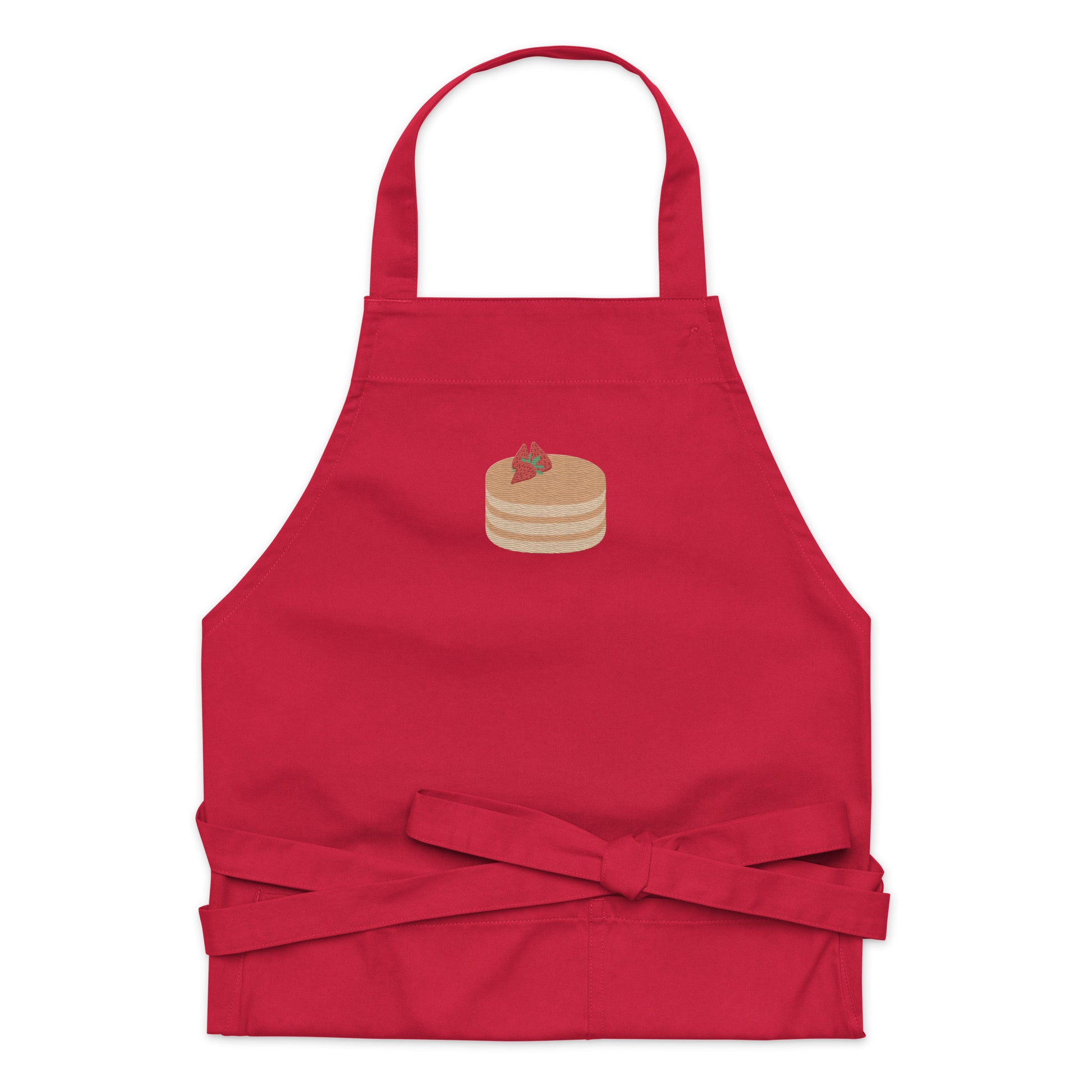 Kitchen apron embroidered on the front. The design is of pancakes with 3 strawberries on top, in a graphic are / vector art style. Apron features 2 front pockets and long straps to be tied behind the wearer in the usual manner. Unisex. One Size. Color: Red. Designed by Brekky Threads.