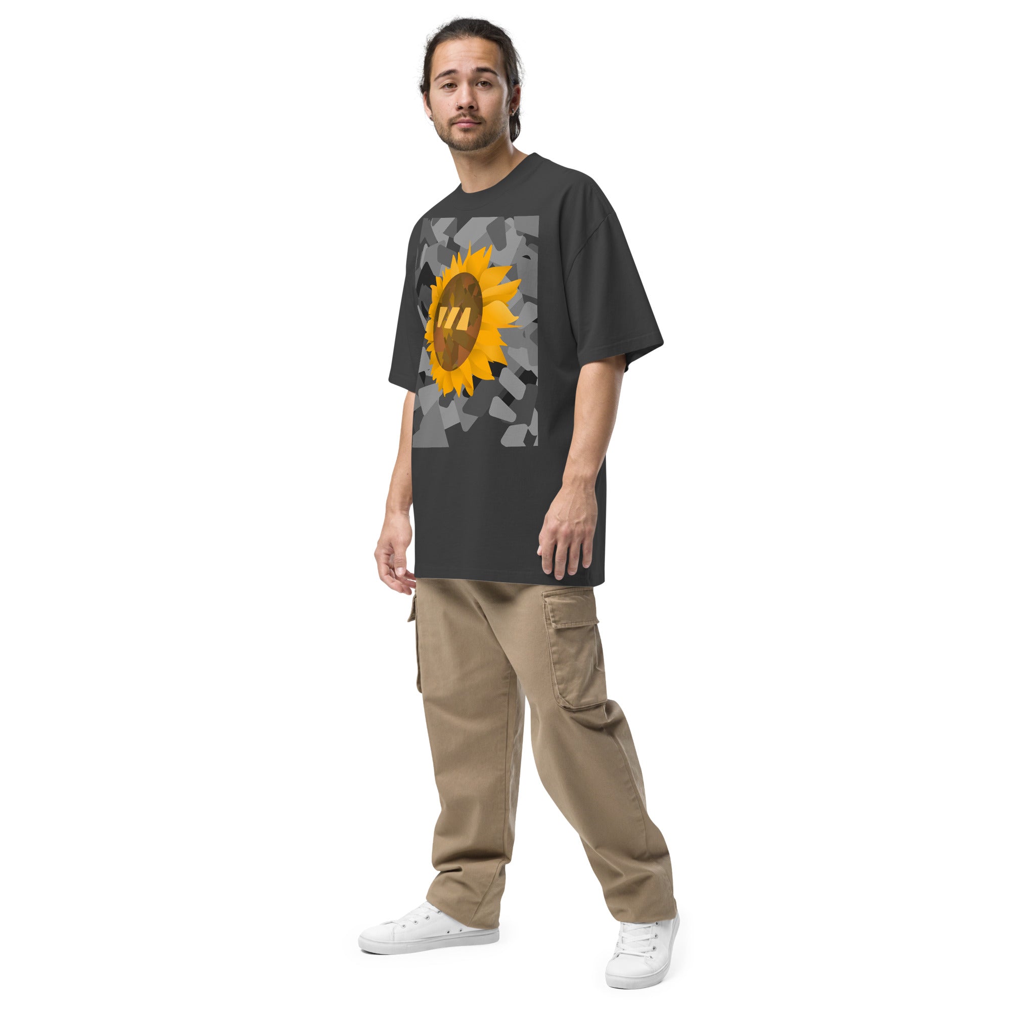 Man wearing the black Sun Flower brekky tshirt, from a side angle. Black t-shirt with a sunflower graphic set on an urban graphic made out of wedges. (Which is what the Brekky logo looks like) PS, he looks really cool.