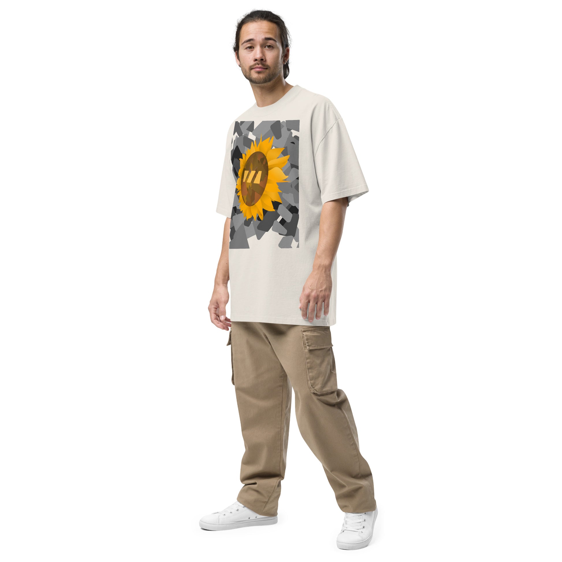 Man wearing the faded bone, Sun Flower brekky tshirt, seen from the side. Faded bone, or off-white, t-shirt with a sunflower graphic set on an urban black-and-white graphic made out of wedges. (Which is what the Brekky logo looks like) PS, he looks really cool.