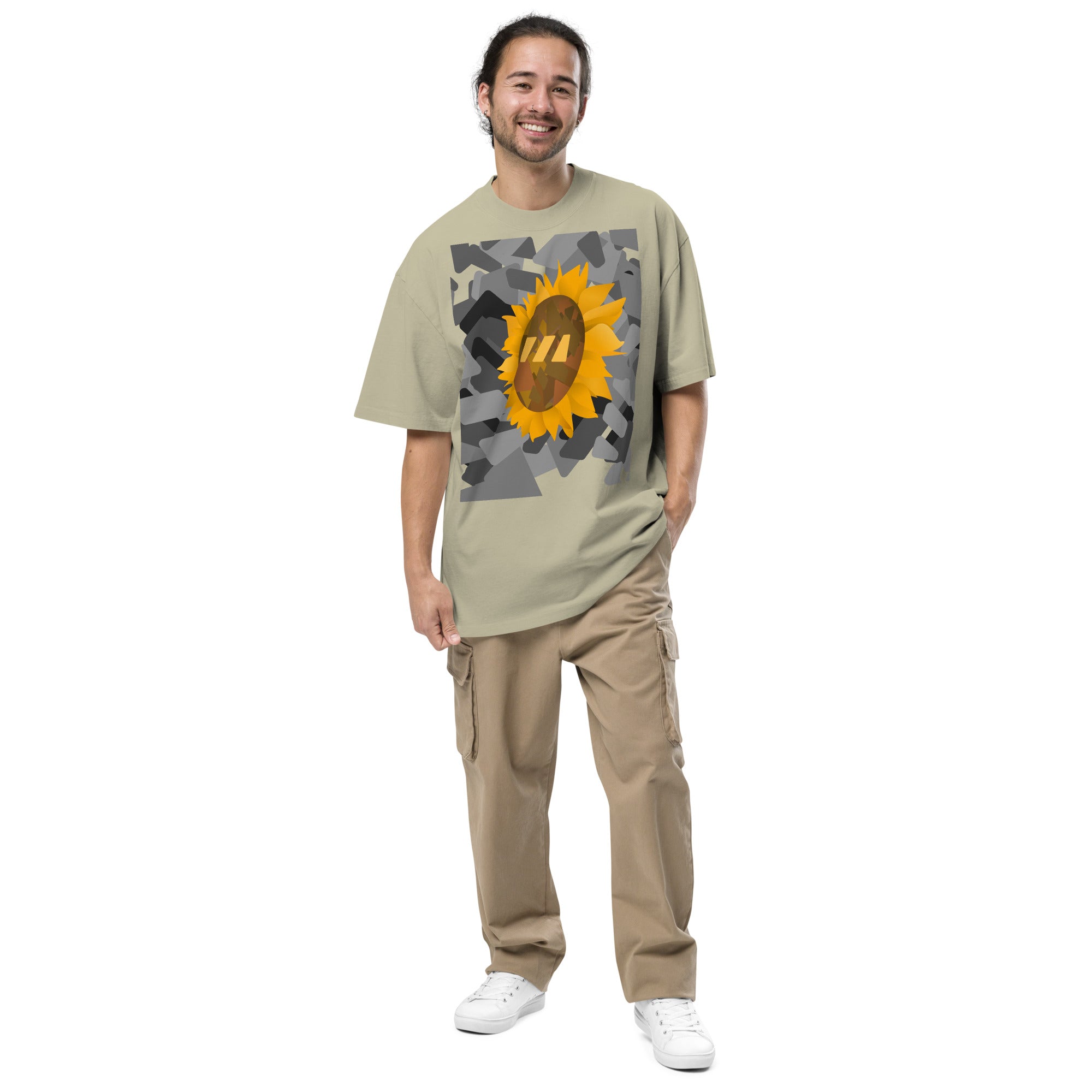 Man wearing the eucalyptus green, Sun Flower brekky tshirt. Eucalyptus green (light natural green hue) t-shirt with a sunflower graphic set on an urban black-and-white graphic made out of wedges. (Which is what the Brekky logo looks like) PS, he looks really cool.