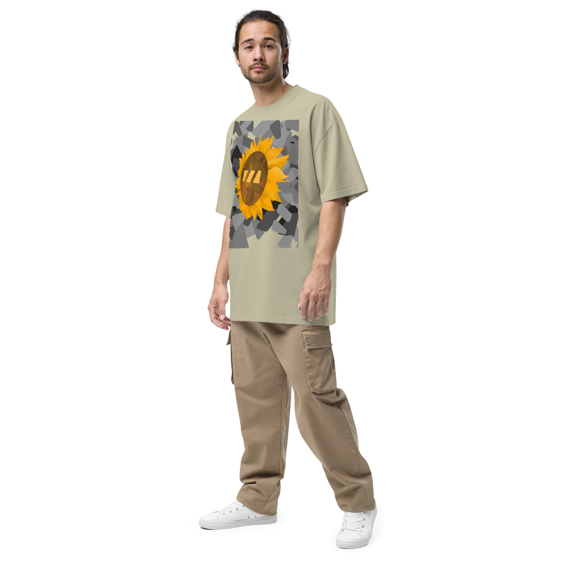 Man wearing the eucalyptus green, Sun Flower brekky tshirt, seen from a side angle. Eucalyptus green (light natural green hue) t-shirt with a sunflower graphic set on an urban black-and-white graphic made out of wedges. (Which is what the Brekky logo looks like) PS, he looks really cool.